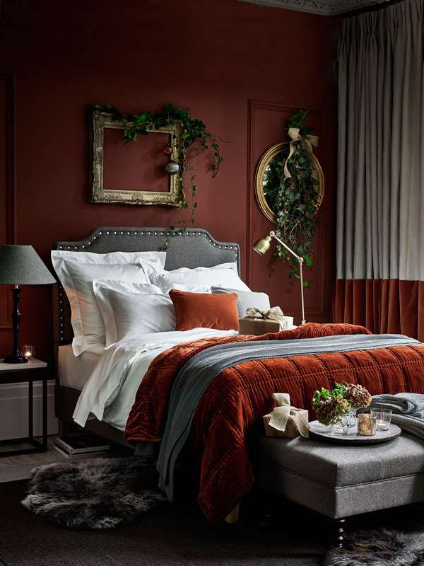 Deep Terracotta Quilt Adds Warmth to Moody Red Walls