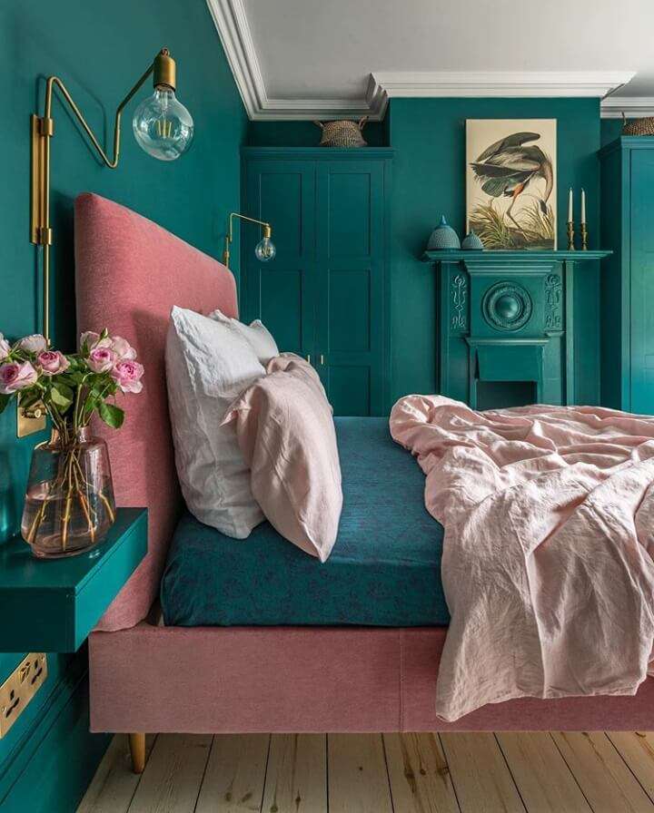 Pink Headboard and Teal Bedding Create a Moody Color Contrast