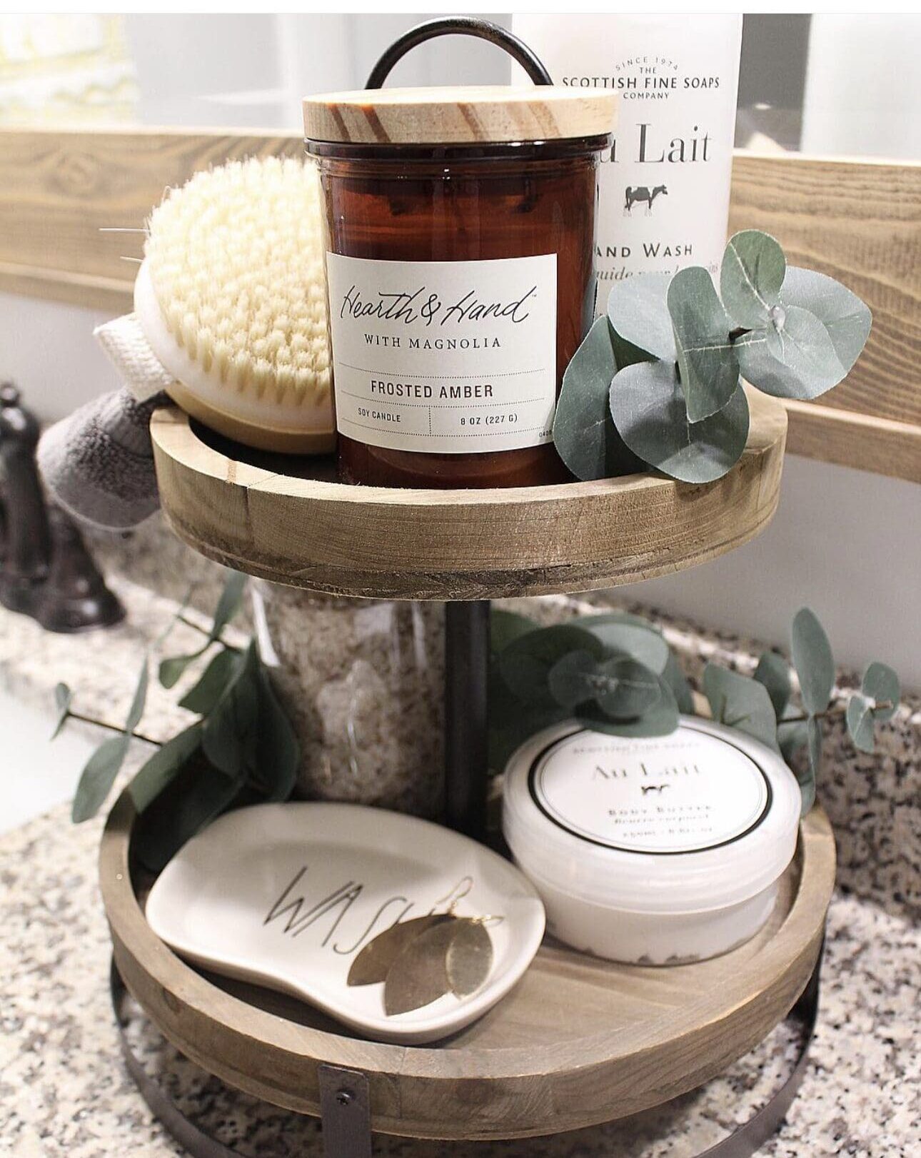 Two-Tiered Wood Stand Groups Bathroom Essentials and Greenery