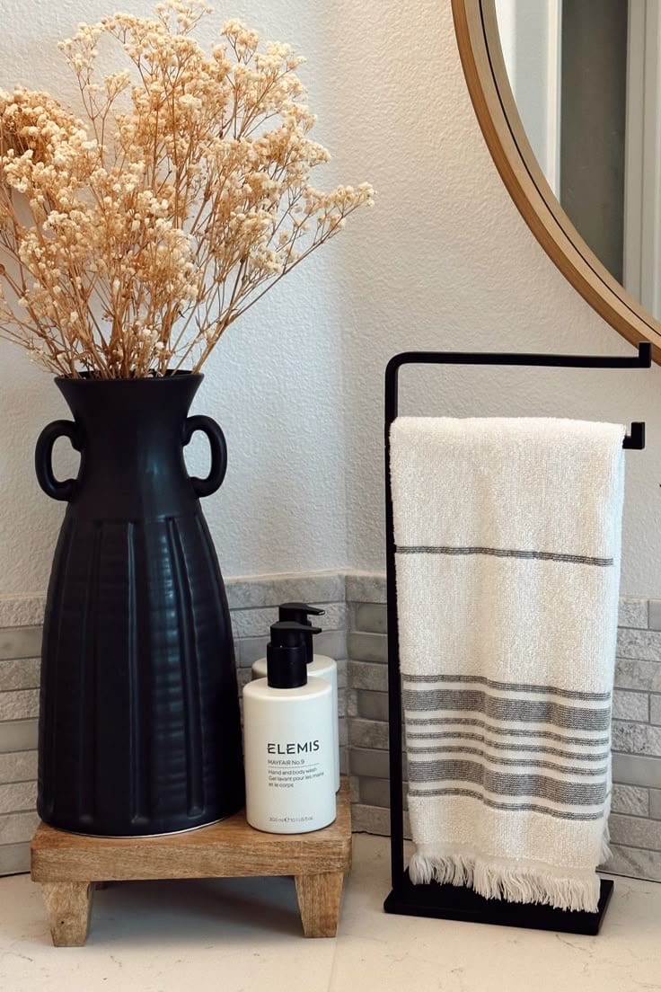 Wooden riser elevates soap dispensers and dried florals