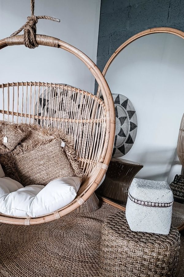 Cozy Boho Haven with rattan hanging chair; perfect boho furniture ideas.