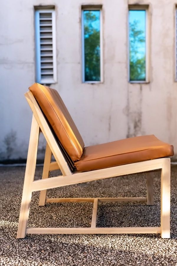 Boho furniture ideas: cozy wooden lounge chair with artistic highlights.