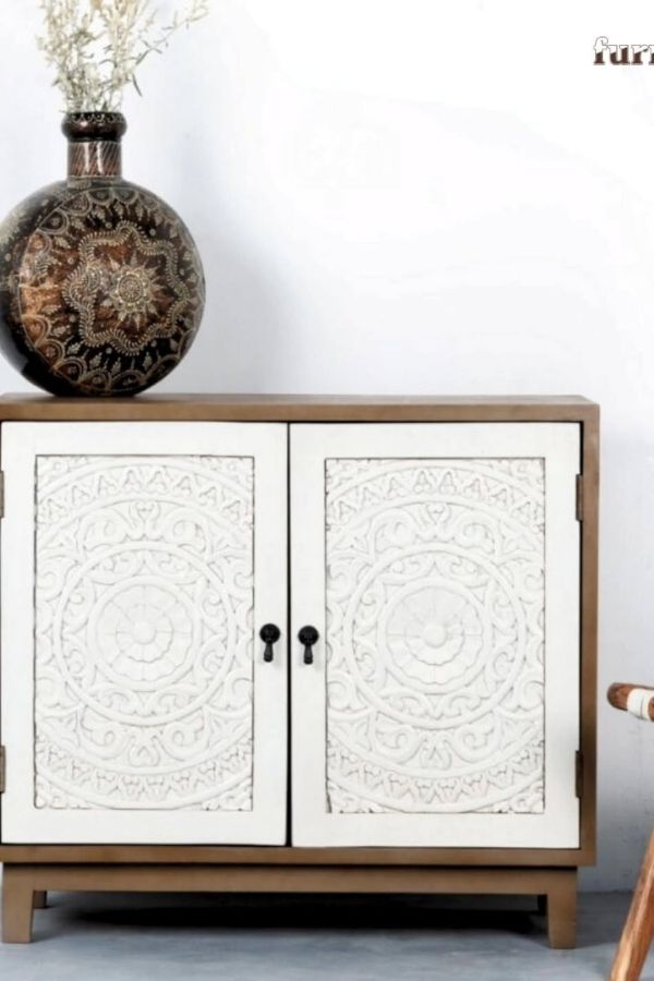 Intricately carved boho cabinet enhances whimsical space; boho furniture ideas.
