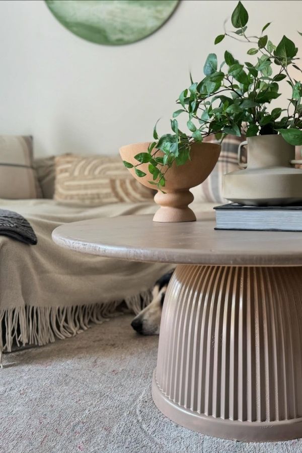 Round ribbed coffee table in boho living room; boho furniture ideas.