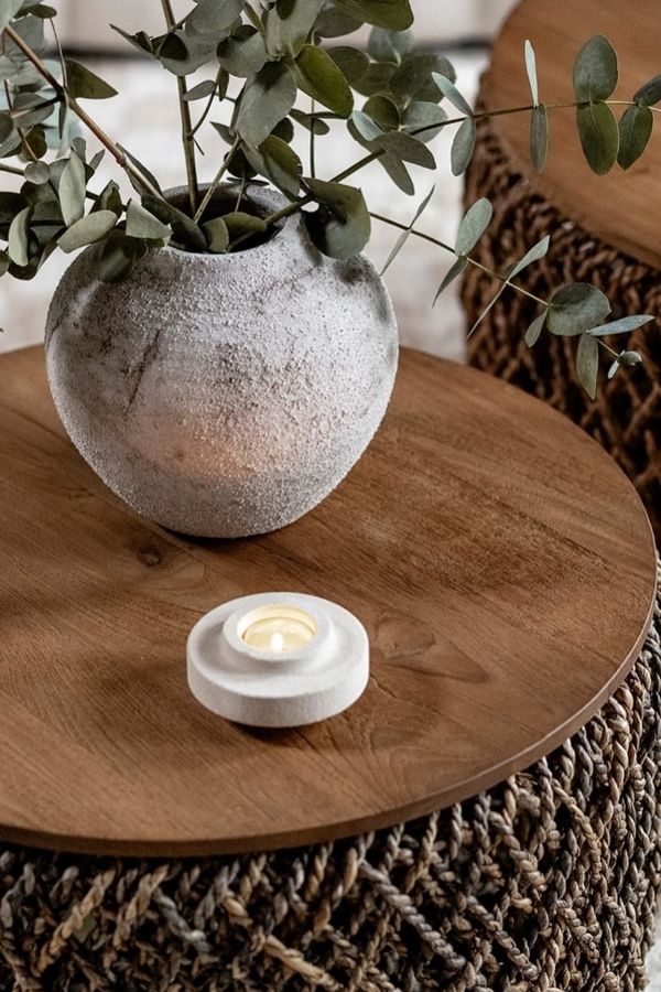 Textured table in cozy boho interior with boho furniture ideas.