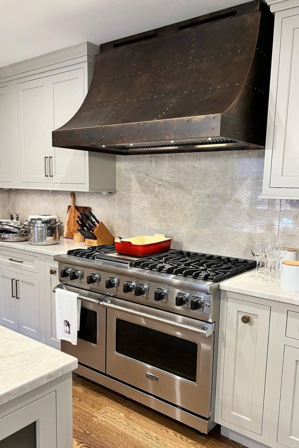 Riveted Metal Hood Adds Industrial Texture Above the Range