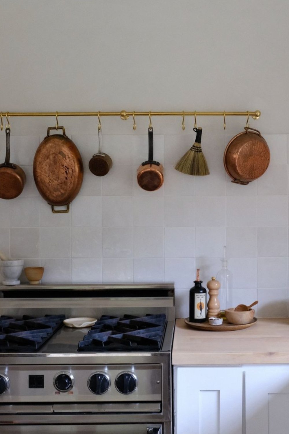 Brass Pot Rail Keeps Cookware Accessible Above Stove