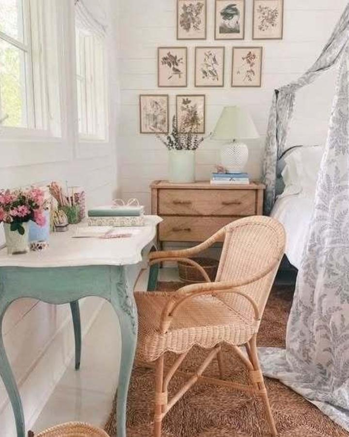 Botanical gallery wall bedroom from @joydecord. Vintage pressed flower prints with rattan chair and sage desk.