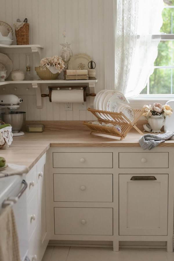 Bamboo dish rack with cream plates from @alliemboss. Natural wood adds warmth to neutral kitchen counter display.