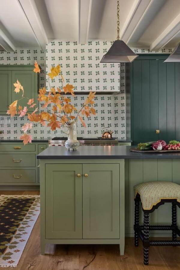 Sage green kitchen cabinets from @katierosenfeld. Geometric wallpaper and brass hardware complete the vintage look.