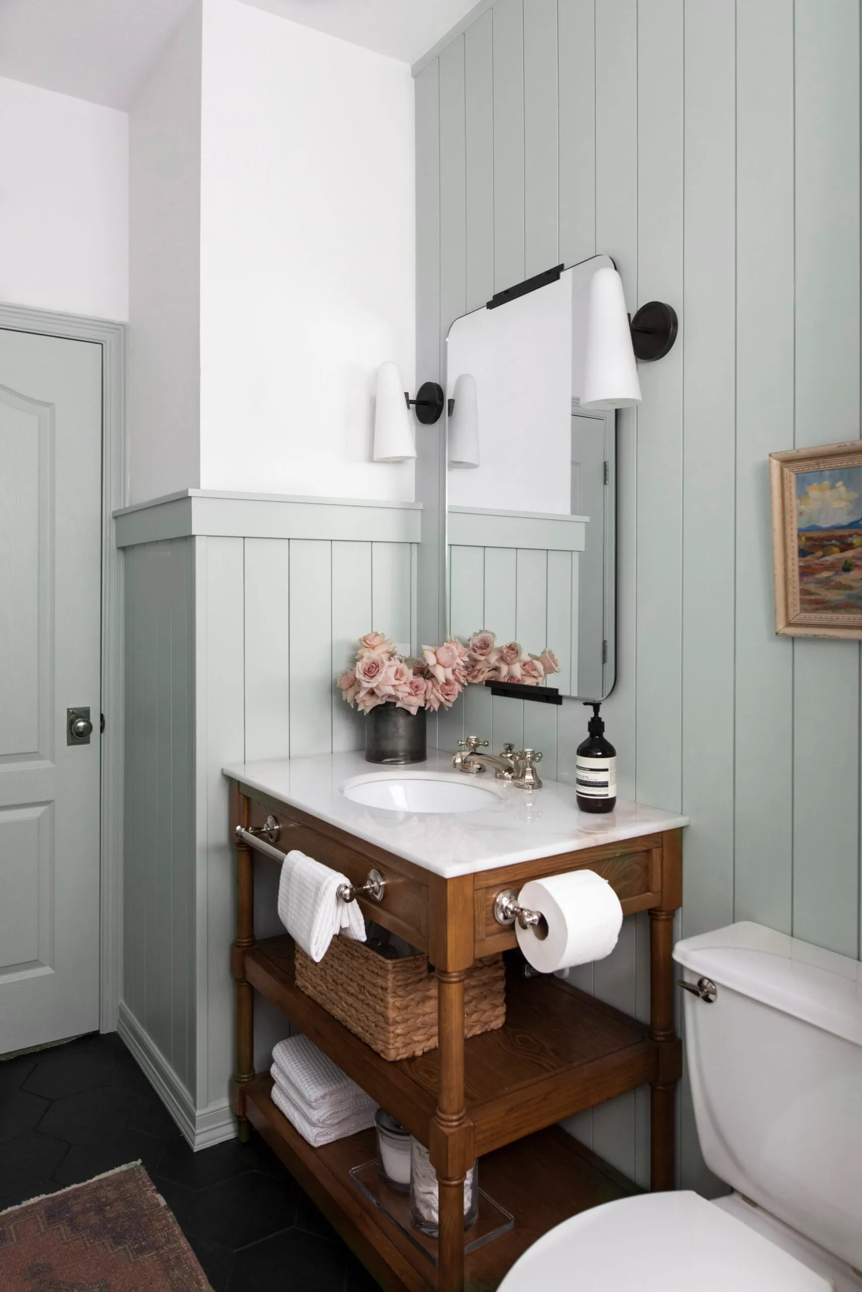 Wooden Vanity With Open Shelves Holds Woven Baskets