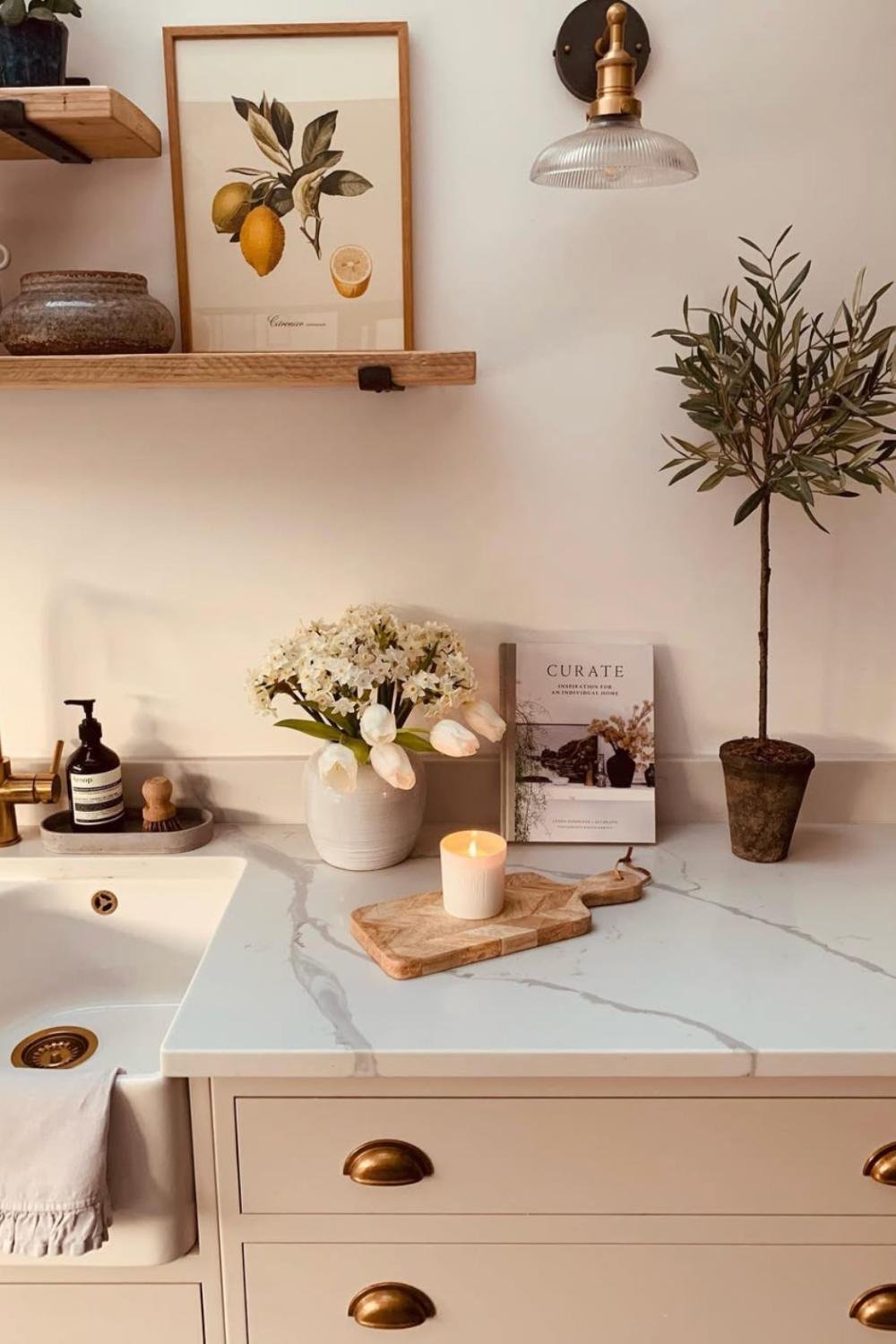 Small Wooden Board Grounds a Lit Candle and Spring Flowers