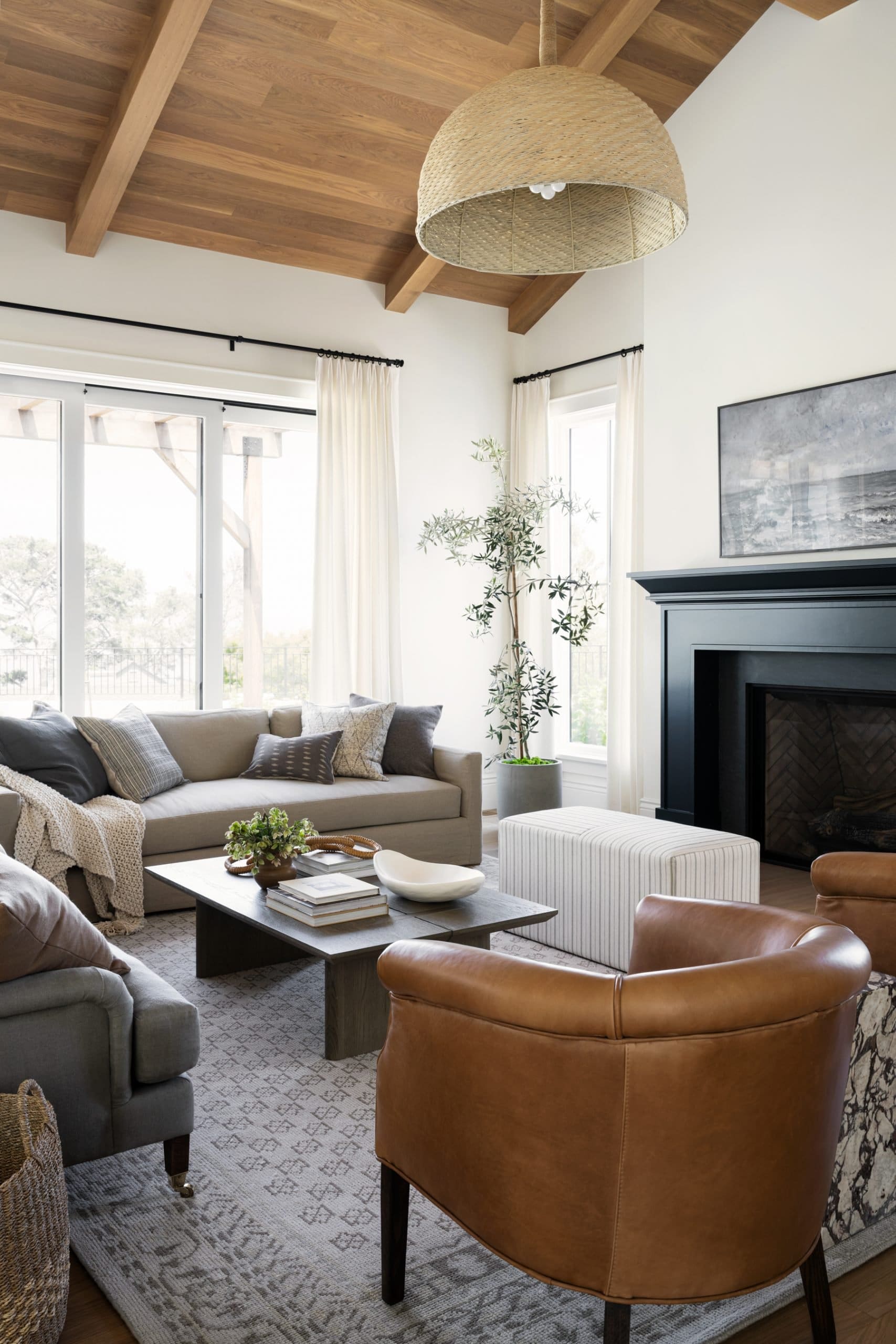 Tan leather armchairs add warm, organic shapes to the seating area