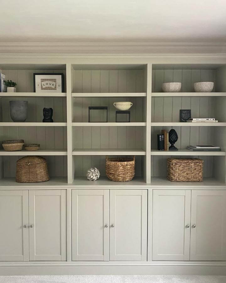 Sage green backed white cabinet showcasing ikea havsta hacks & ideas from @renovationrivendell with woven basket storage