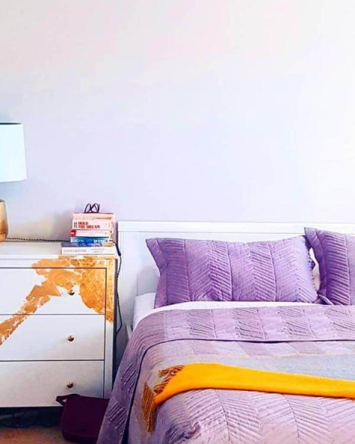 White Ikea Koppang dresser with gold leaf accent next to lavender bed from @denton_house ikea koppang hacks.