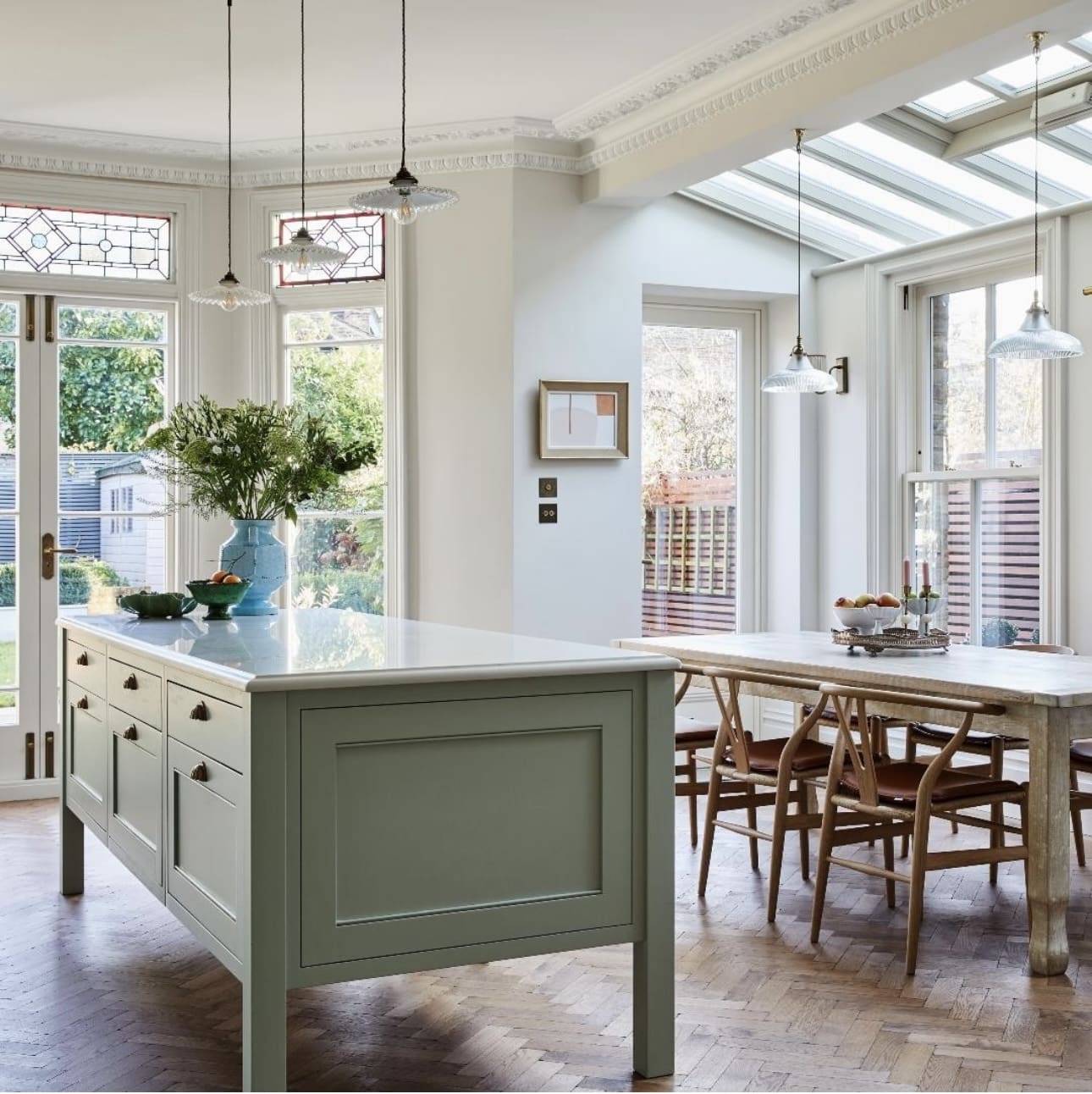 Sage green island with inset paneled doors and drawers