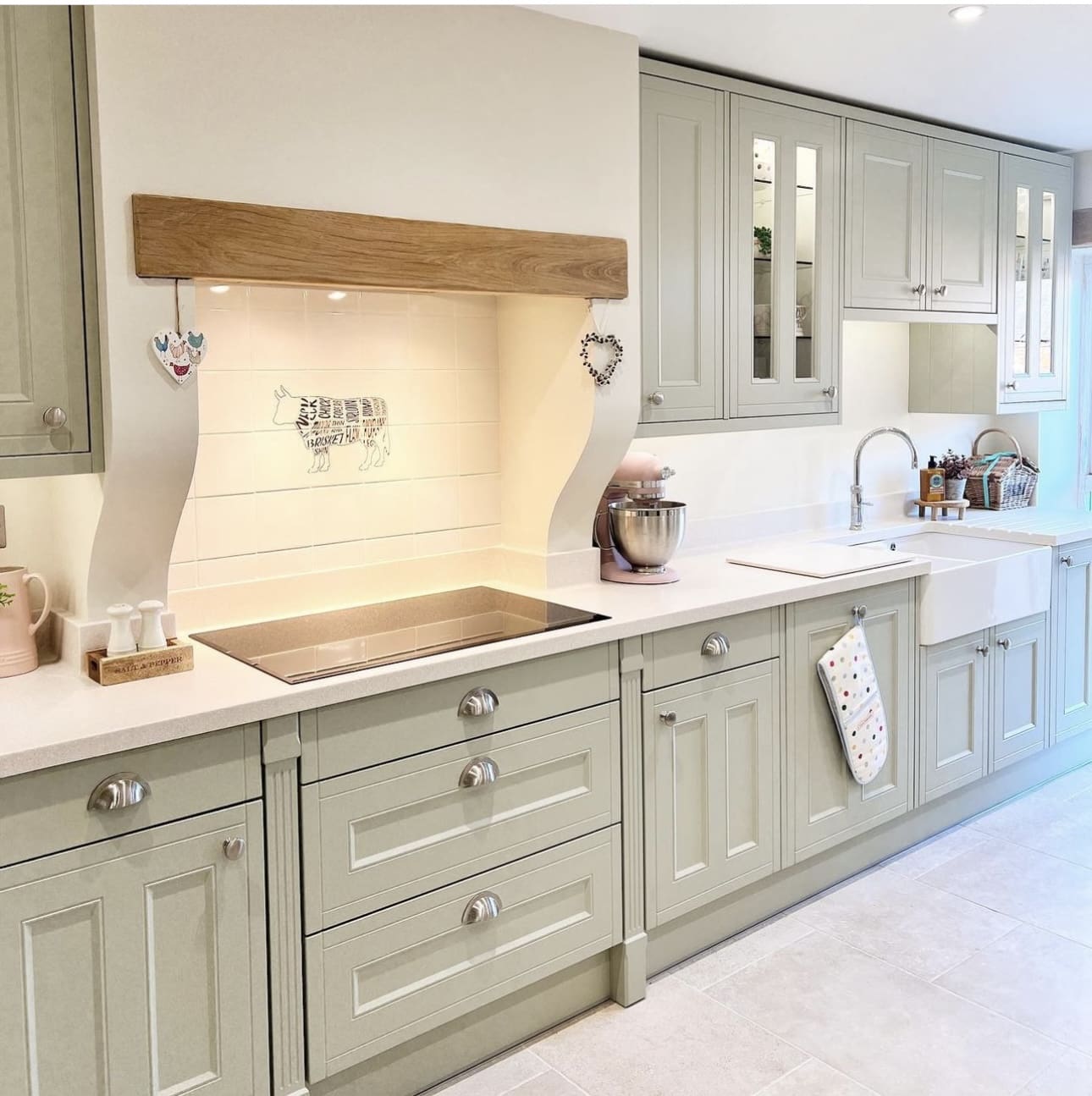 Rustic oak mantel frames a whimsical cow tile backsplash