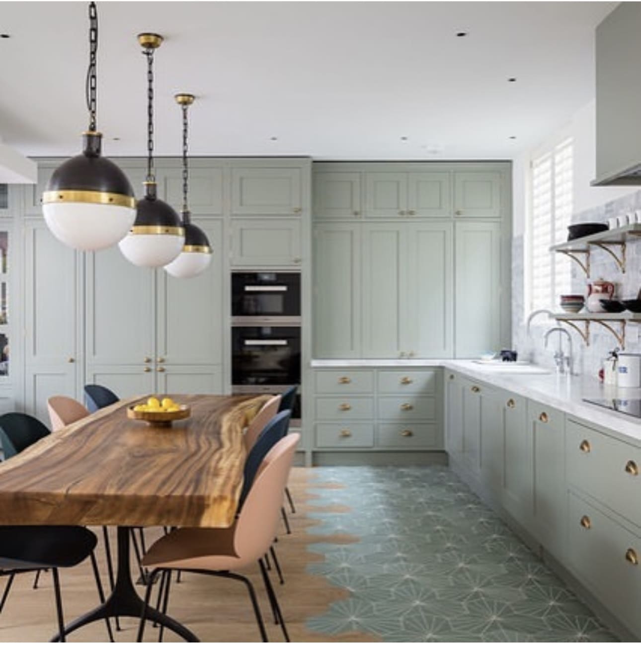 Sage green geometric floor tiles add a unique pattern