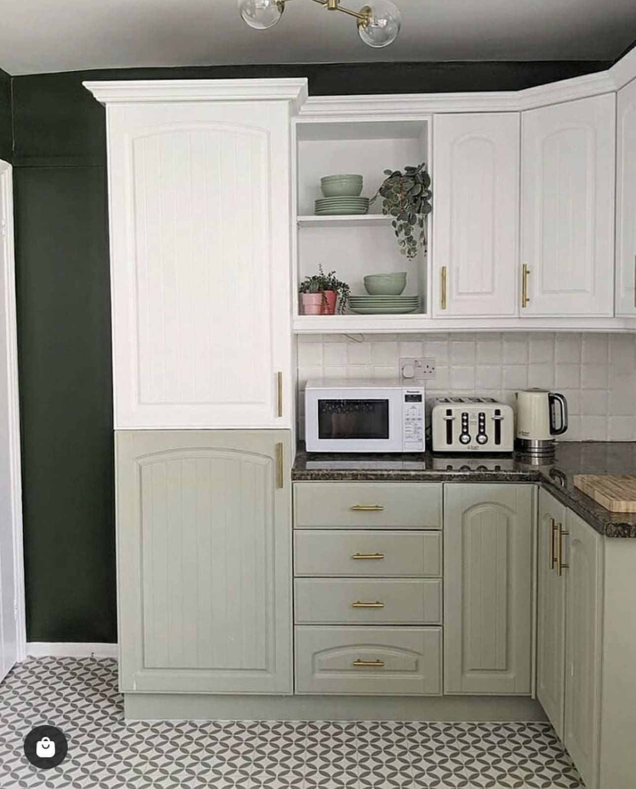 Sage green lower cabinets with arched inset panels