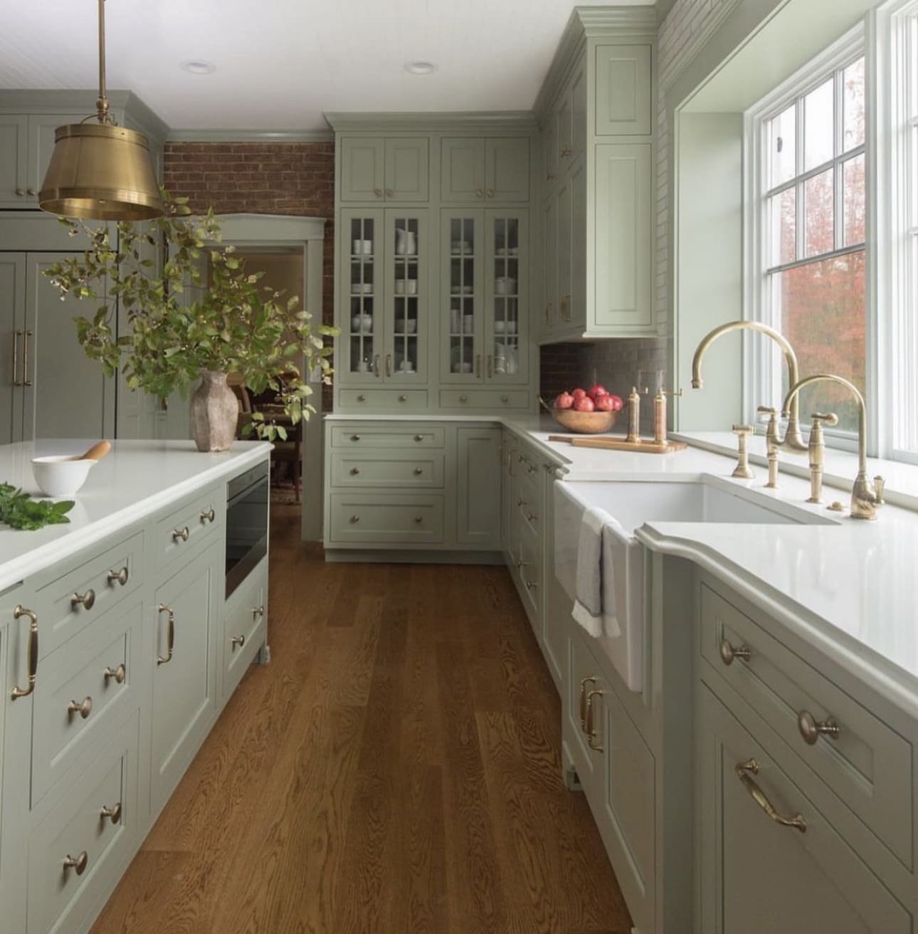 Brass bridge faucet with a farmhouse sink adds vintage charm