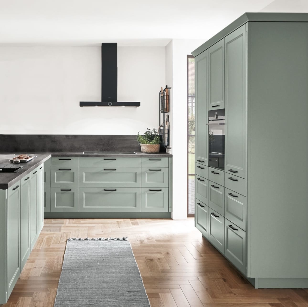 Sage green cabinets with sleek, minimalist black bar pulls