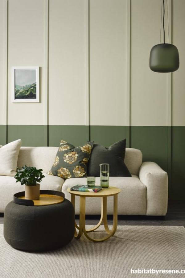 Sage and cream walls create soothing living room panelling harmony.