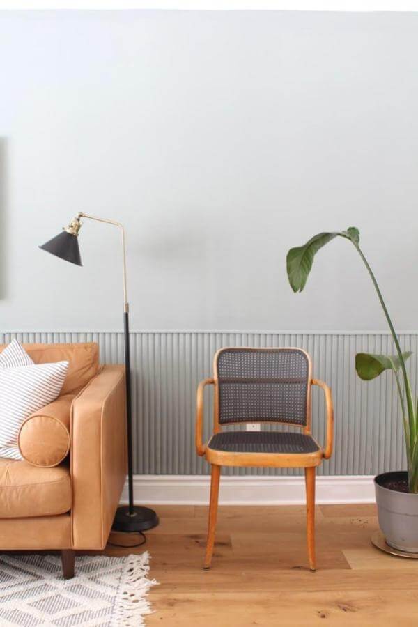Sage-hued walls enhance the modern space with minimalist panel design.