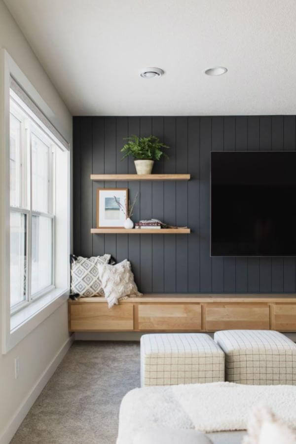 Cozy nook enhanced by contemporary charcoal accent and panelled wall.