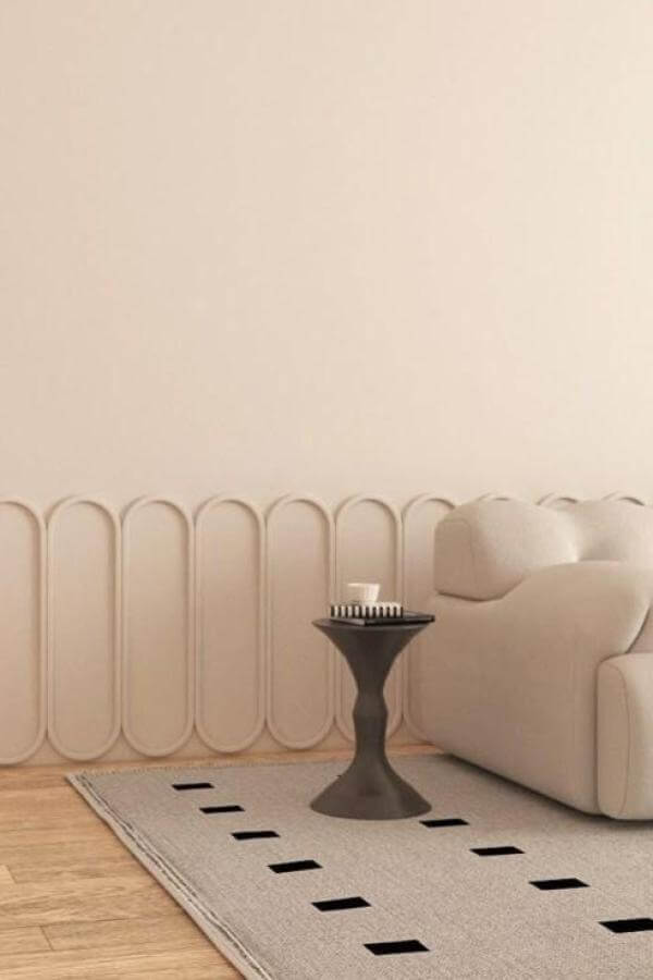 Sculptural wall design enhances elegance in contemporary living room space.