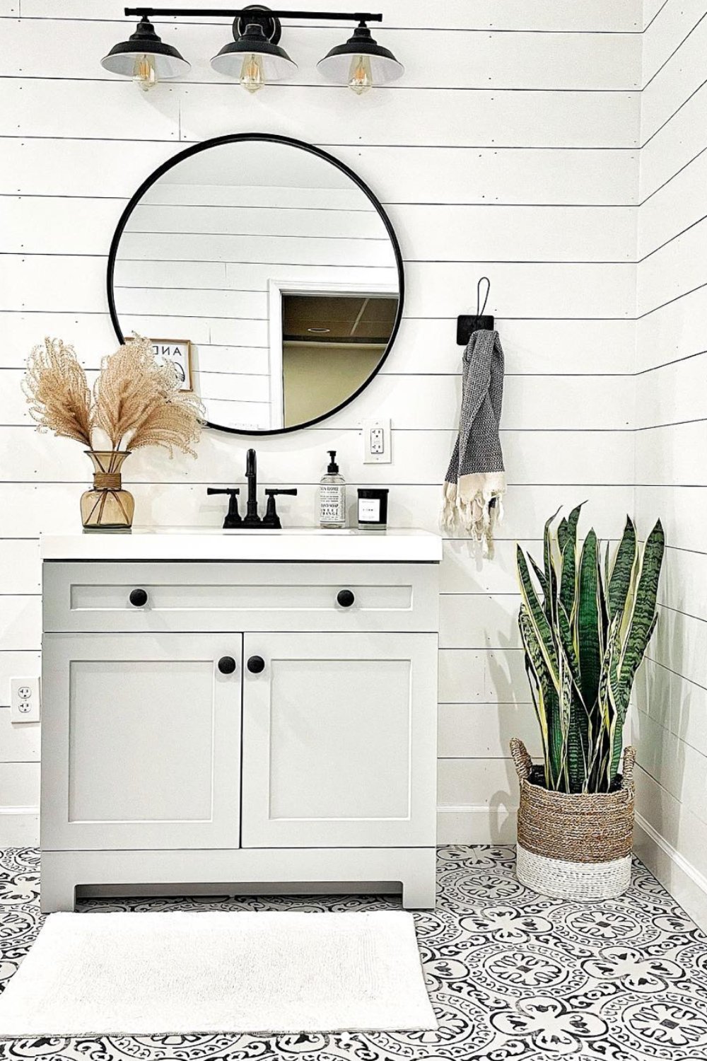Round Black Mirror Above White Vanity Adds Modern Contrast
