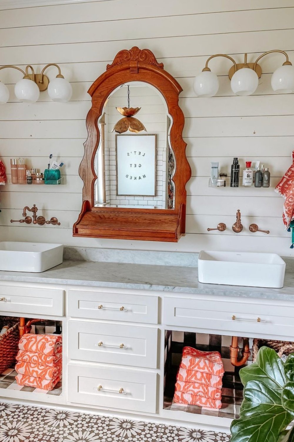 Ornate Wooden Mirror Frames the Bathroom Vanity