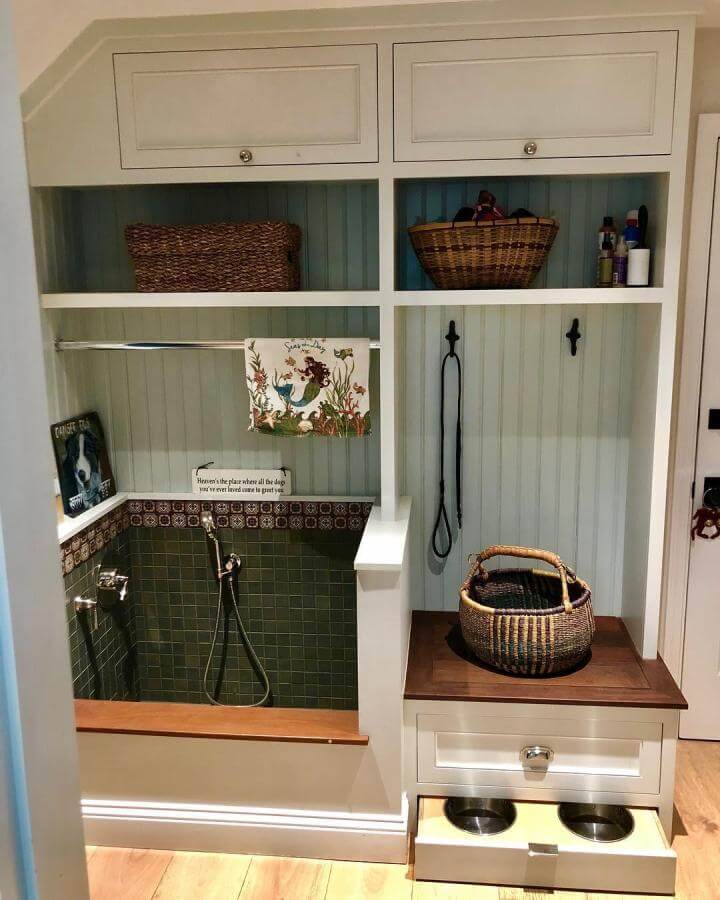 Woven baskets and green tile built-in dog washing station with wood bench and beadboard walls from @kristinkilmer showing practical rustic mudroom pet setup
