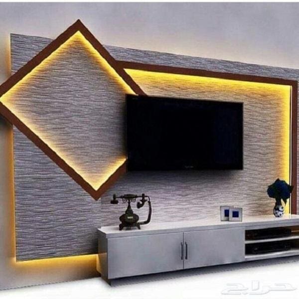 Angled Wood Frame Highlights Recessed TV With Warm Lighting