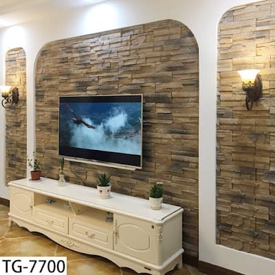 Textured Stone Archway Frames TV With Symmetrical Sconces