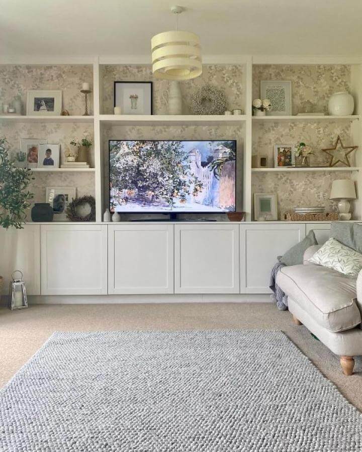 White classic door media center with open shelves and patterned wallpaper from @townhouse_on_the_green showcasing ikea media center hacks & ideas.