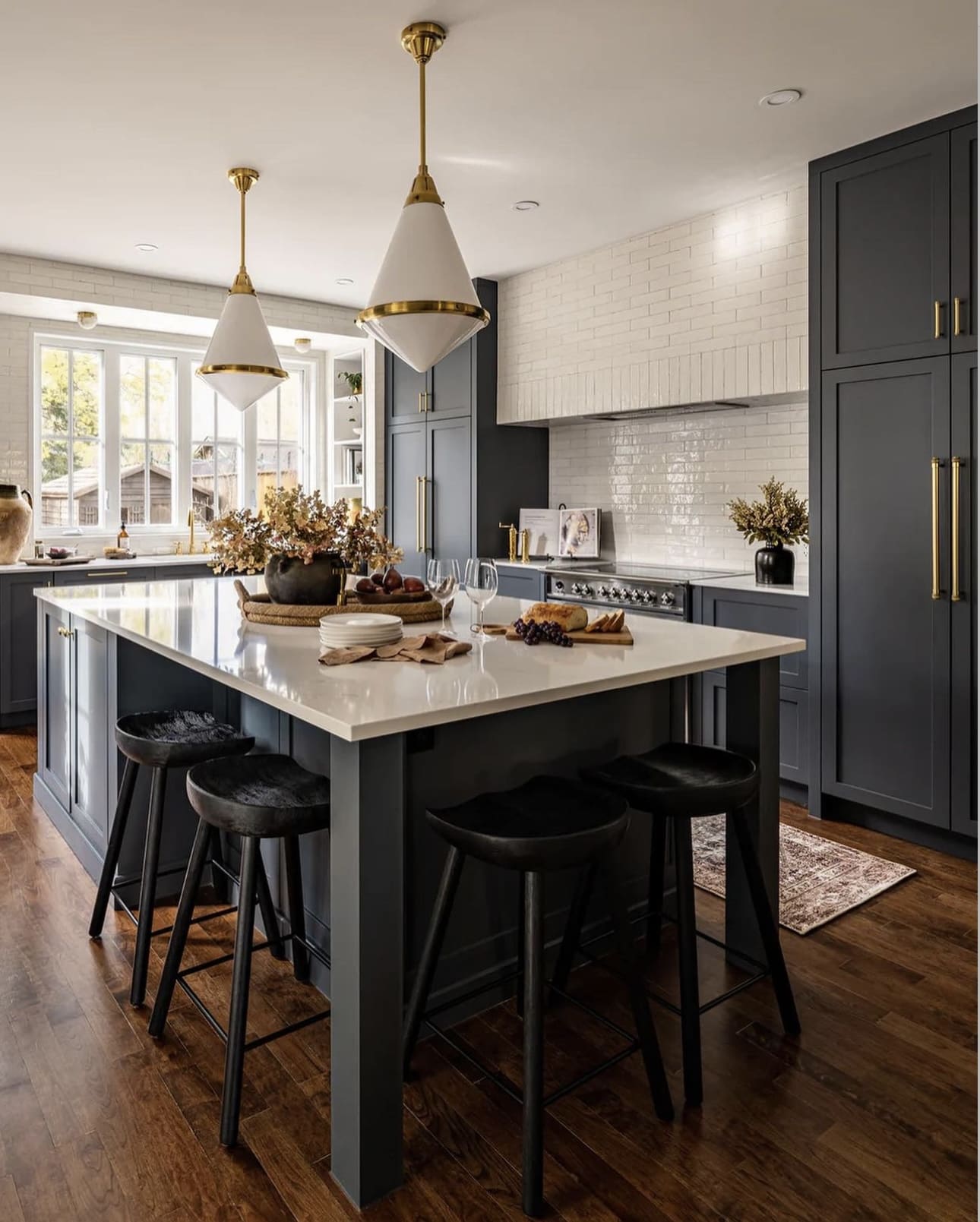 Bright Contrast: White Subway Tile Backsplash Above Blue Cabinets
