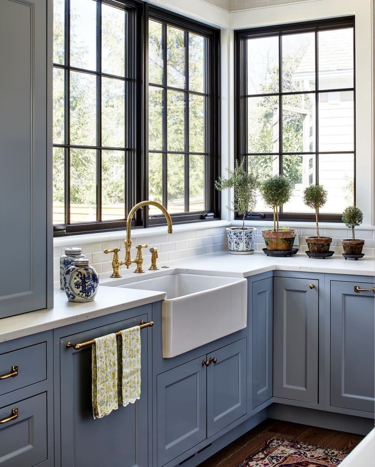 Convenient Touch: Brass Bar for Towels on Blue Cabinets
