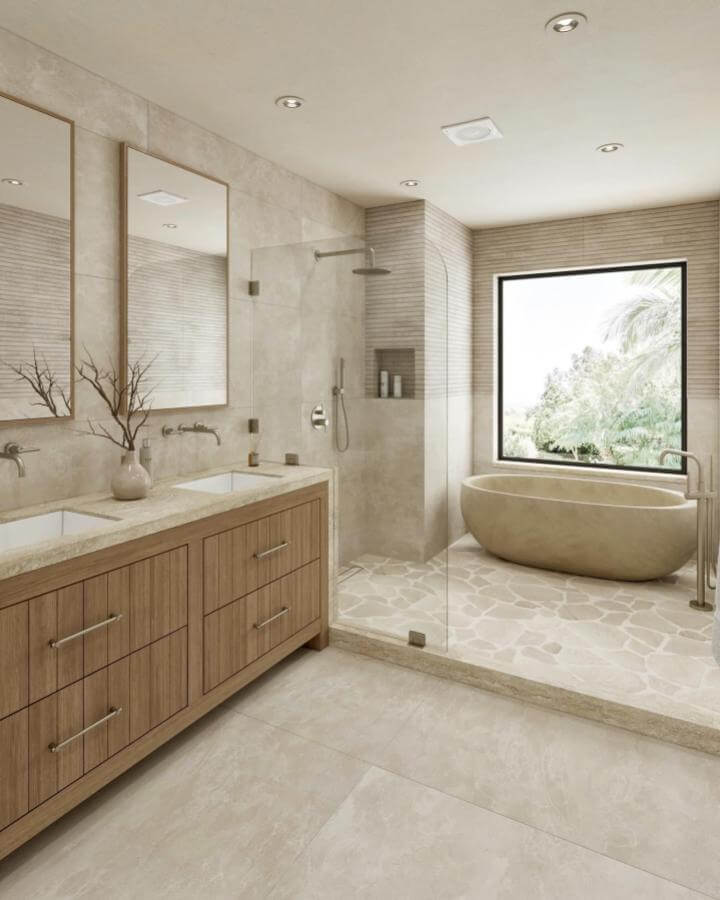 Natural beige stone bathtub and textured shower walls in a light-filled bathroom from @create_interior_design1. Cozy natural stone bathroom ideas ambiance.