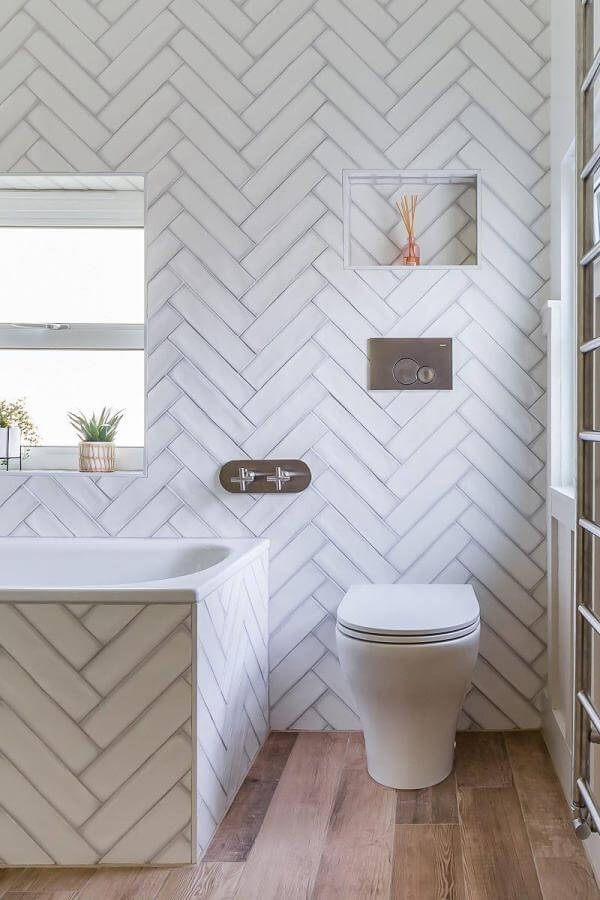Rustic wood herringbone tiles from @thebromleybathroomcompany. Perfect blend of elegance and charm for a stylish bathroom.
