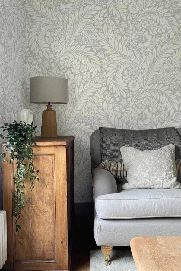 Botanical patterns create serene harmony with calming grey wallpaper tones.