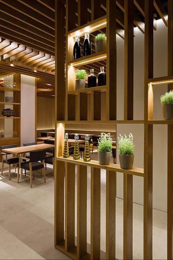 Warm wood slats create chic space, enhancing room divider ideas.