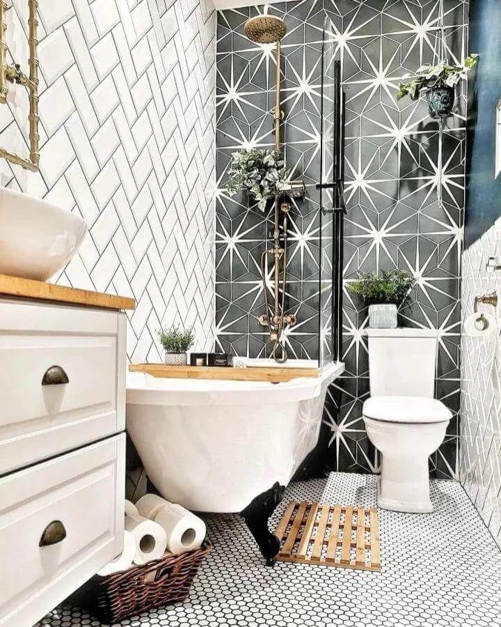 Black and white star pattern tiled bathroom from @louisecinspo featuring bold geometric walls and vintage brass fixtures for tiny apartment bathroom ideas.